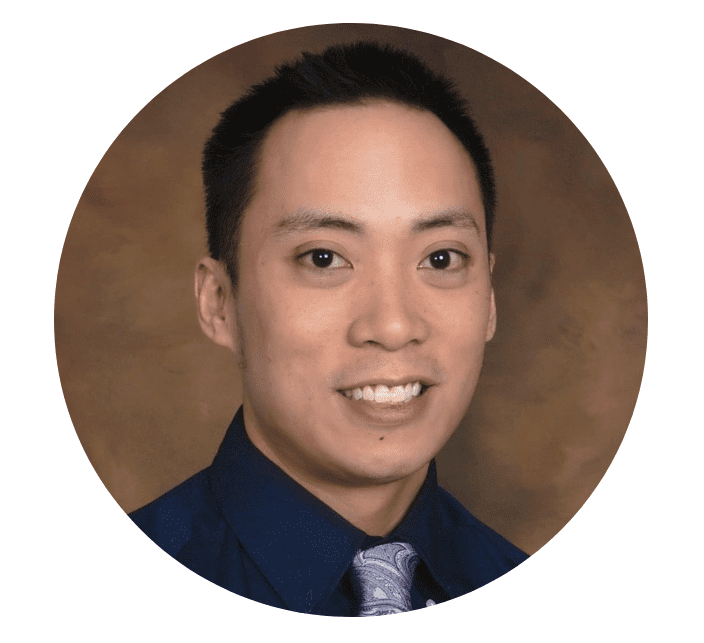 A portrait of a man in a blue shirt and tie.